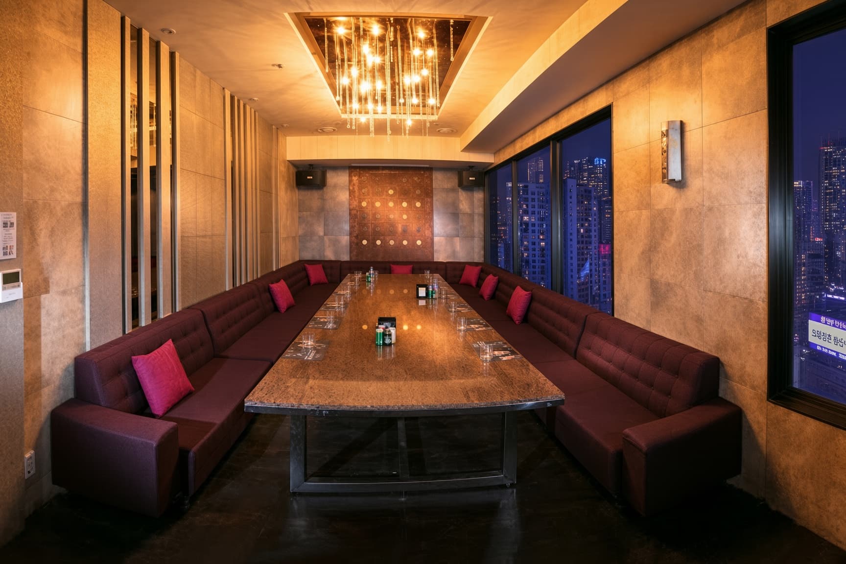 Gangnam Sky (강남 스카이) · Red sofas line both sides of a long table beneath decorative ceiling lights.